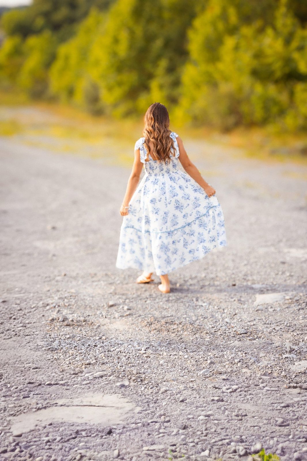 A child walking along a country path at golden hour